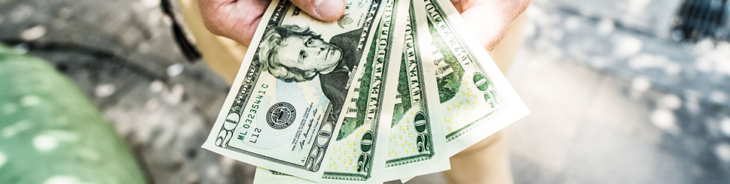 Health Insurance Costs. Four American twenty dollar bills are shown.