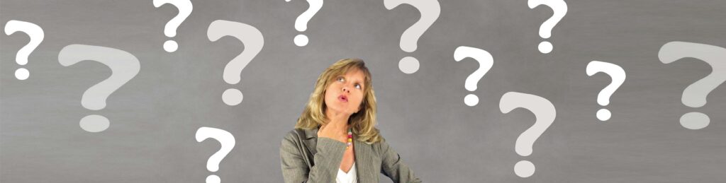 A woman surrounded by question marks looking pensive